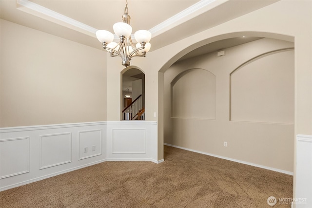 4504 5th Ave NW, Olympia, WA 98502 - carpeted spare room featuring arched walkways, a chandelier, a raised ceiling, and crown molding