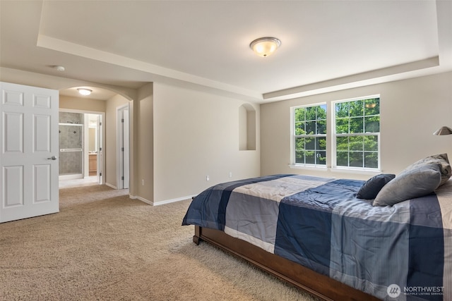 4504 5th Ave NW, Olympia, WA 98502 - carpeted bedroom with arched walkways, a raised ceiling, and connected bathroom