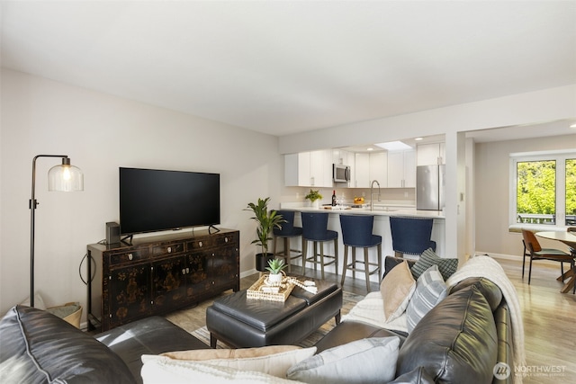 8957 Watson Pl NE, Bremerton, WA 98311 - living area featuring baseboards and wood finished floors