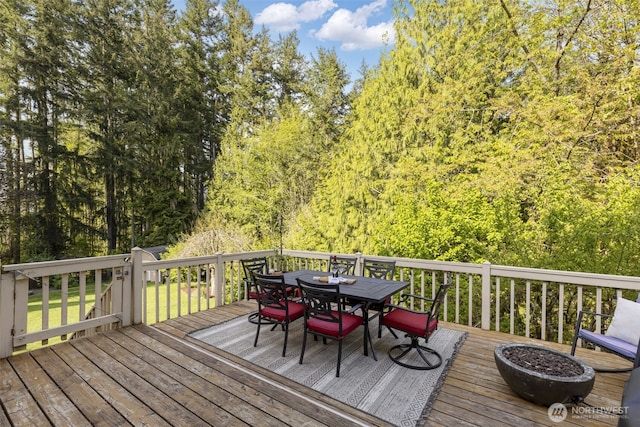 8957 Watson Pl NE, Bremerton, WA 98311 - wooden deck featuring a wooded view and outdoor dining area