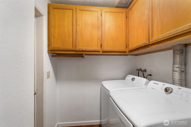 8957 Watson Pl NE, Bremerton, WA 98311 - laundry area featuring washing machine and dryer, cabinet space, baseboards, and visible vents