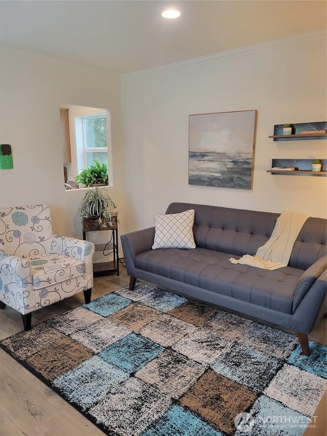 living area with crown molding and wood finished floors