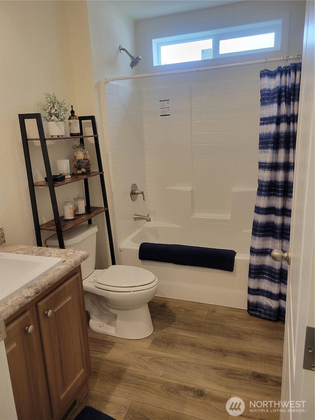 full bathroom featuring vanity, shower / bath combo with shower curtain, toilet, and wood finished floors