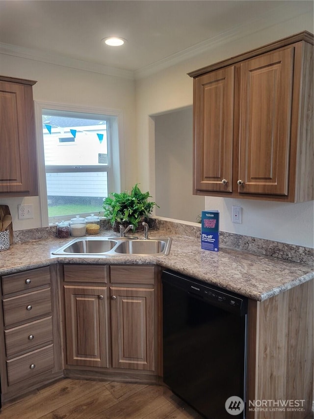 kitchen featuring crown molding, wood finished floors, black dishwasher, light countertops, and a sink