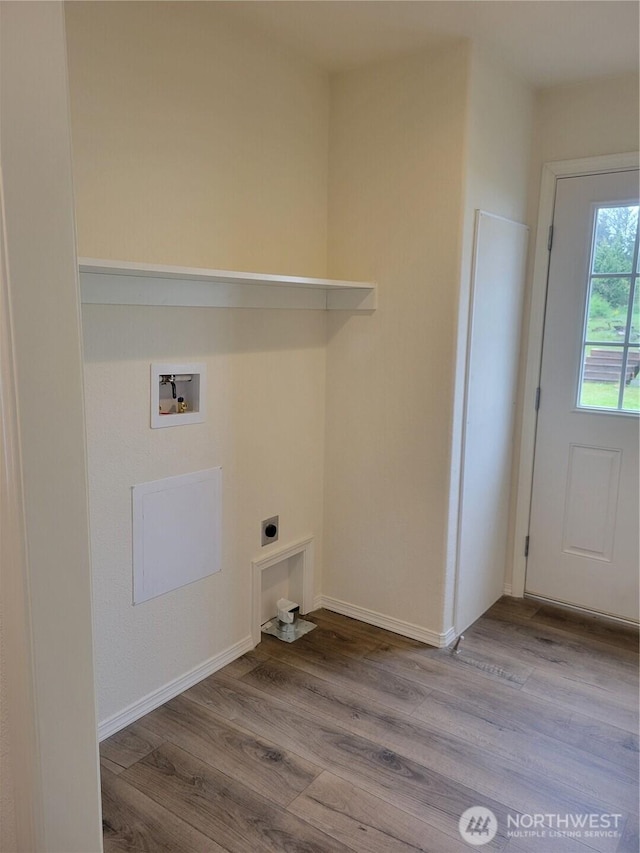 laundry room featuring baseboards, electric dryer hookup, wood finished floors, and hookup for a washing machine