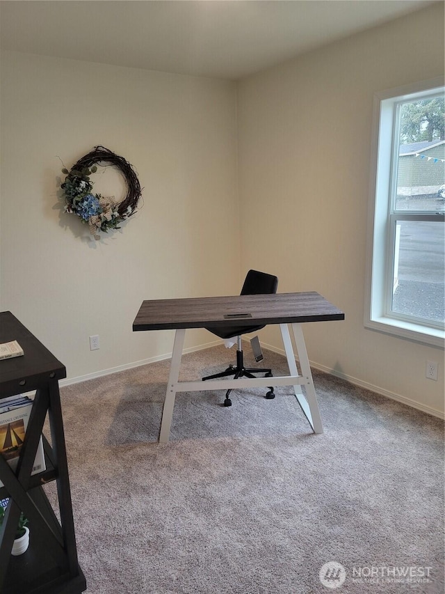 carpeted office space featuring baseboards