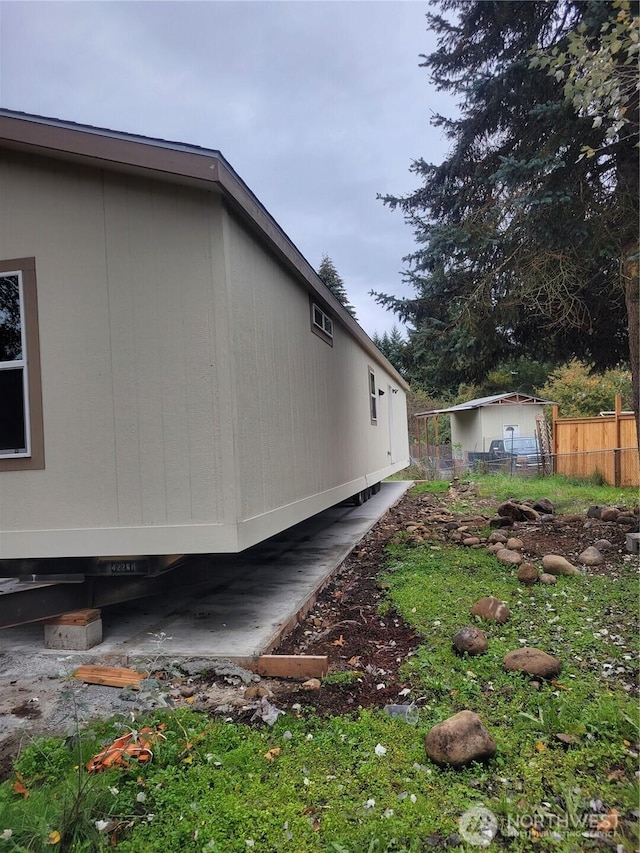view of home's exterior featuring fence