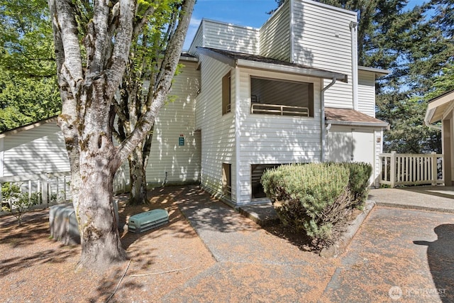 view of side of home featuring a shingled roof
