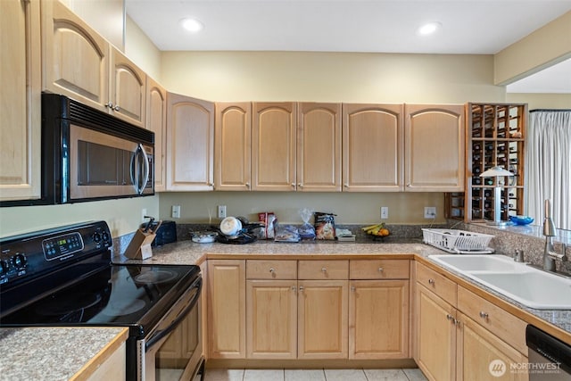 kitchen featuring tile counters, a sink, light brown cabinets, and stainless steel appliances