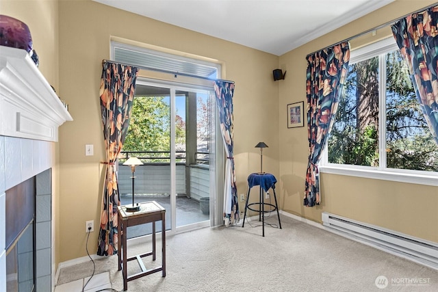 interior space with baseboards, access to outside, baseboard heating, and a tile fireplace