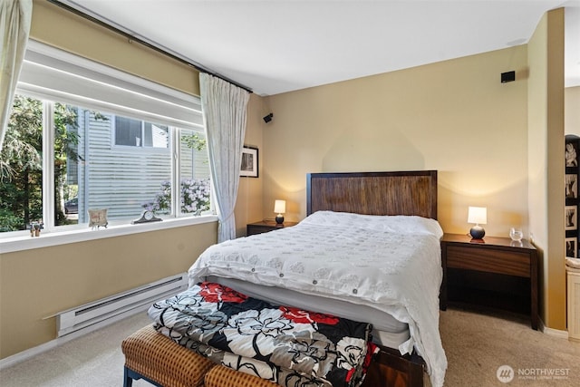bedroom with baseboards, a baseboard heating unit, and carpet