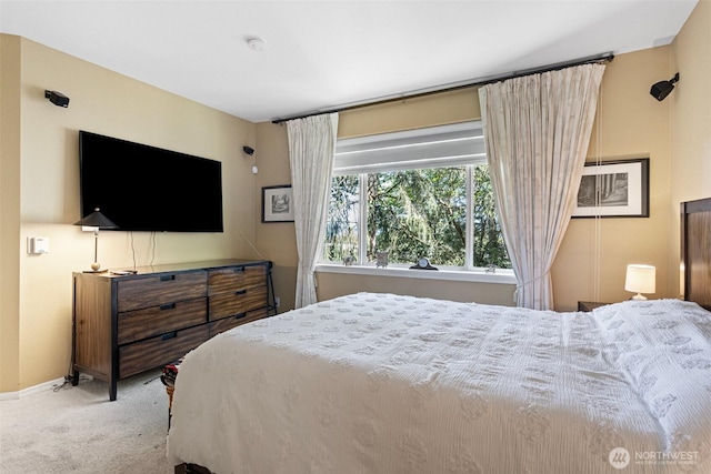 carpeted bedroom featuring baseboards