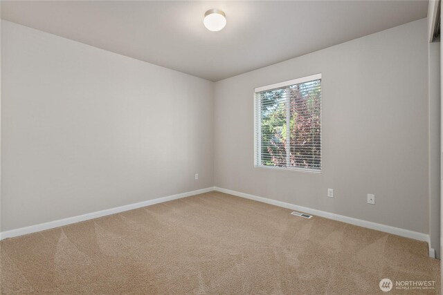 unfurnished room featuring baseboards and carpet flooring