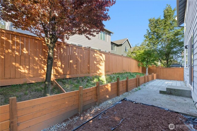fenced backyard featuring a patio