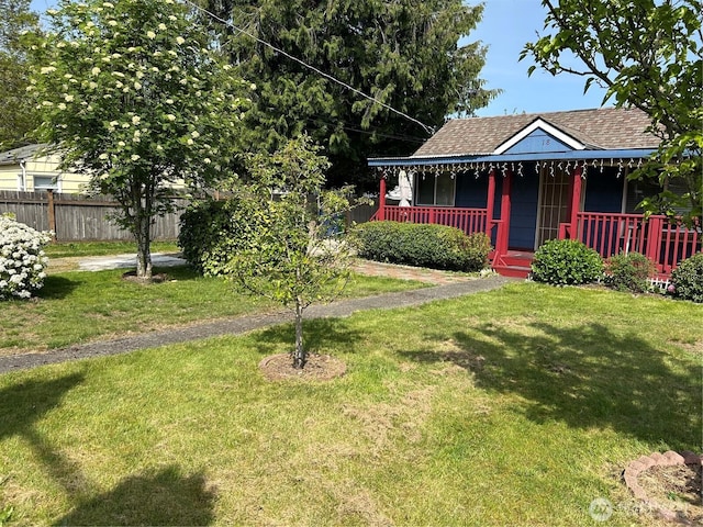 14118 37th Ave S, Tukwila, WA 98168 - view of front of house featuring roof with shingles, fence, covered porch, and a front yard