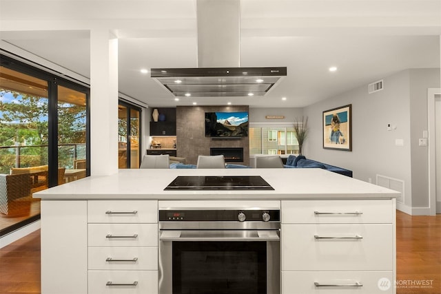 807 Lake St S Unit 300, Kirkland, WA 98033 - kitchen with island range hood, visible vents, black electric cooktop, stainless steel oven, and recessed lighting