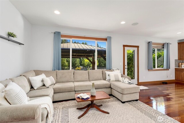living room featuring dark wood-style floors, recessed lighting, and baseboards