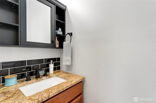 bathroom featuring tasteful backsplash and vanity