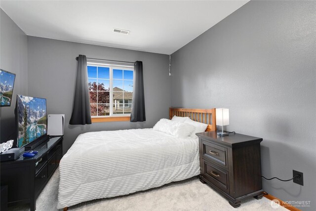 bedroom with light colored carpet