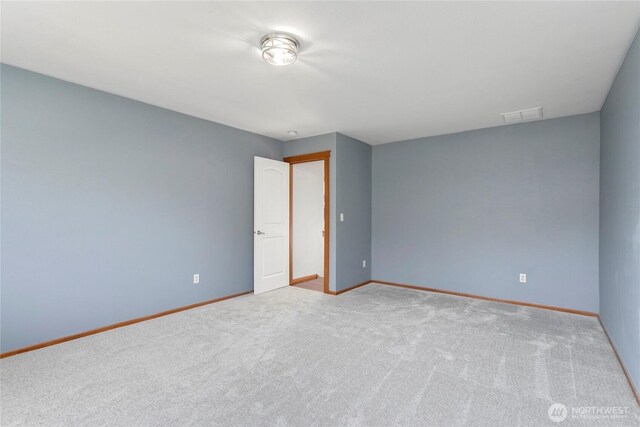 spare room with carpet floors and baseboards