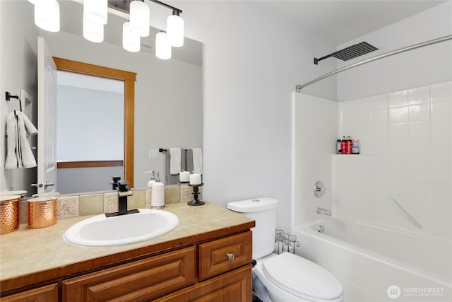 bathroom with toilet, vanity, and bathing tub / shower combination