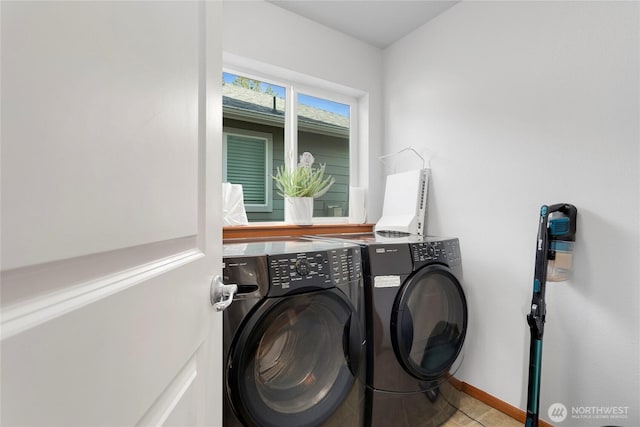 washroom featuring washing machine and clothes dryer and baseboards
