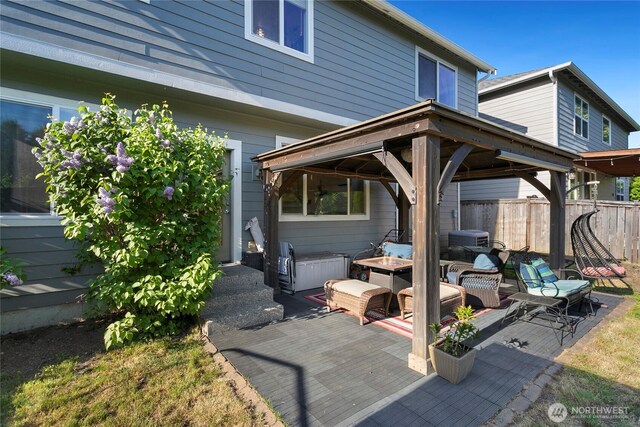 view of patio featuring a gazebo, fence, and a deck