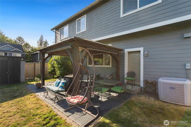 view of patio / terrace with central air condition unit and a shed