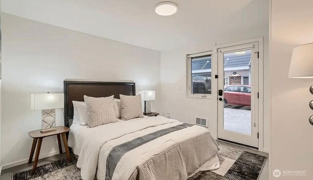 bedroom featuring visible vents, baseboards, and access to outside