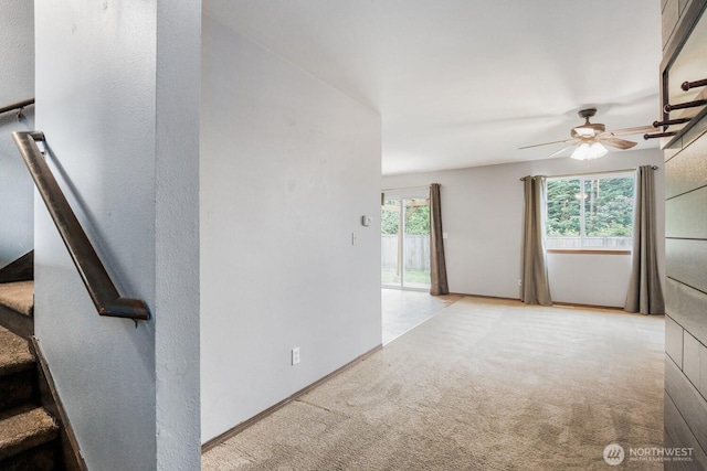 spare room featuring carpet flooring and a ceiling fan