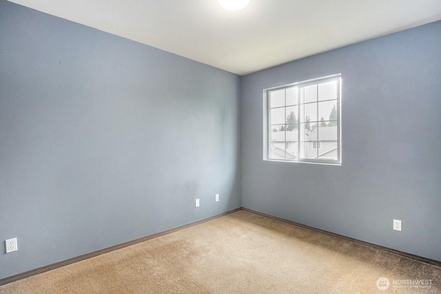 unfurnished room featuring baseboards and carpet flooring