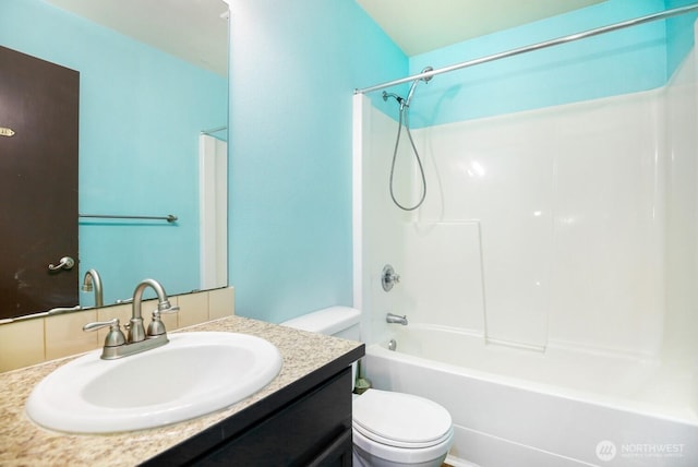 bathroom featuring vanity, toilet, and bathing tub / shower combination