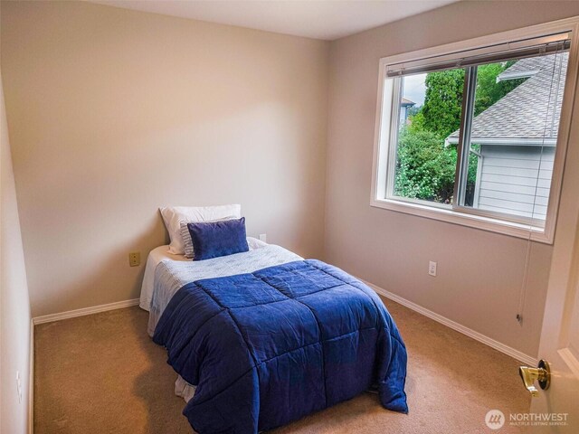 bedroom featuring carpet flooring and baseboards