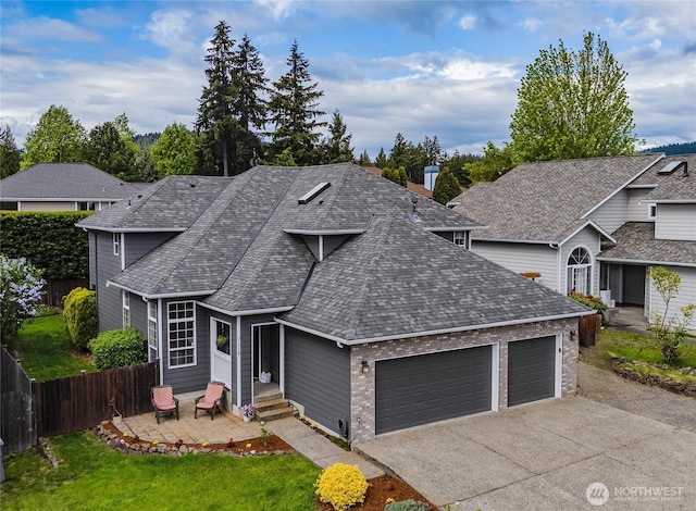 1618 Hoquiam Pl NE, Renton, WA 98059 - traditional-style house with an attached garage, fence, driveway, a shingled roof, and entry steps