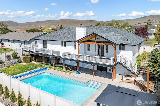 5208 Tumac Dr, Yakima, WA 98901 - rear view of property featuring a fenced backyard, a deck with mountain view, and stairway
