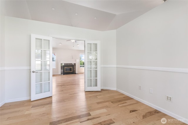 5208 Tumac Dr, Yakima, WA 98901 - empty room featuring french doors, a high end fireplace, baseboards, and wood finished floors