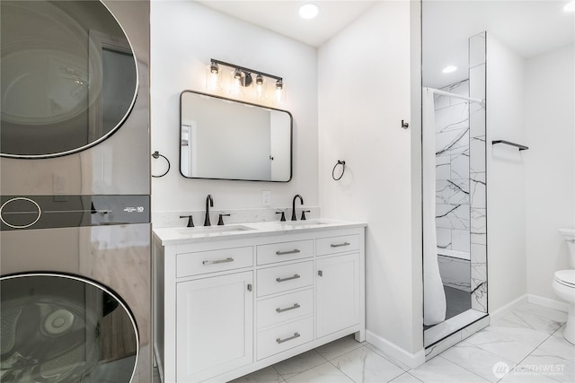 5208 Tumac Dr, Yakima, WA 98901 - bathroom with stacked washer and dryer, marble finish floor, toilet, baseboards, and a sink