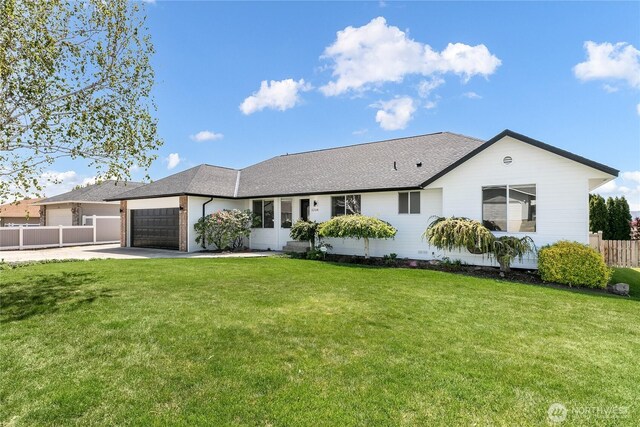 5208 Tumac Dr, Yakima, WA 98901 - ranch-style home with fence, a shingled roof, a front lawn, a garage, and concrete driveway