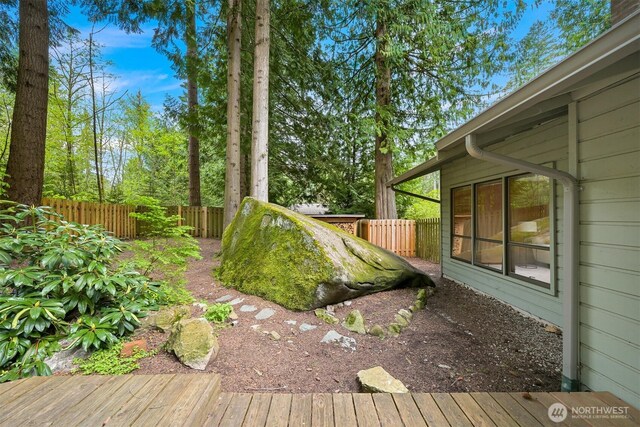 view of yard featuring a fenced backyard and a deck
