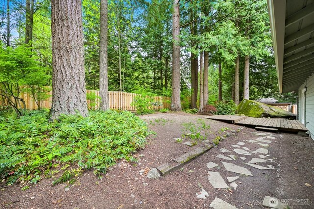 view of yard featuring fence and a deck