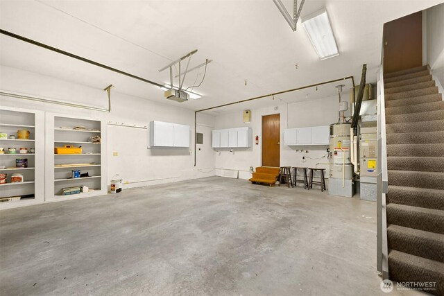 garage featuring gas water heater and a garage door opener