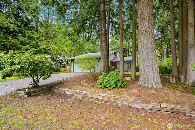 obstructed view of property with a garage