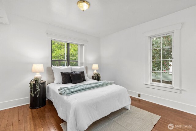 bedroom featuring baseboards and wood finished floors