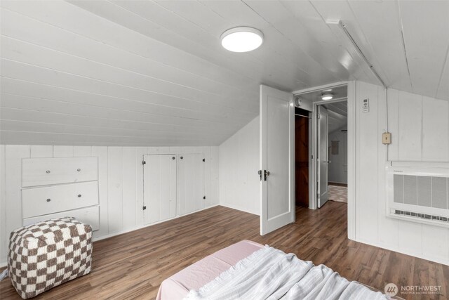 bonus room featuring heating unit, wood finished floors, and vaulted ceiling
