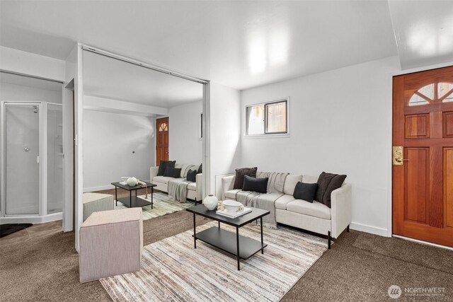 carpeted living area with baseboards