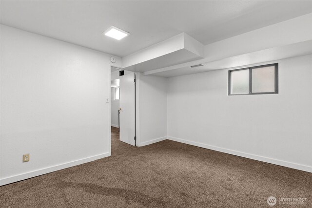 basement with baseboards and carpet flooring