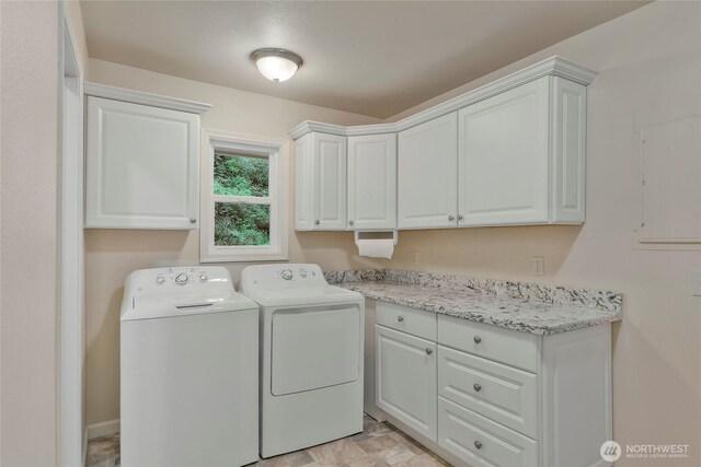 laundry room featuring washer and clothes dryer and cabinet space