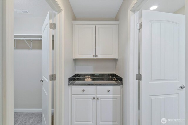 bar featuring baseboards and visible vents