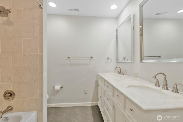 full bath featuring baseboards, a sink, shower / tub combination, and tile patterned floors
