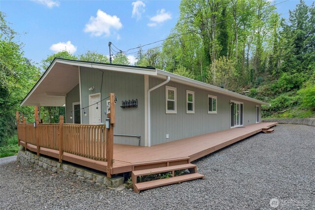 back of house featuring a wooden deck
